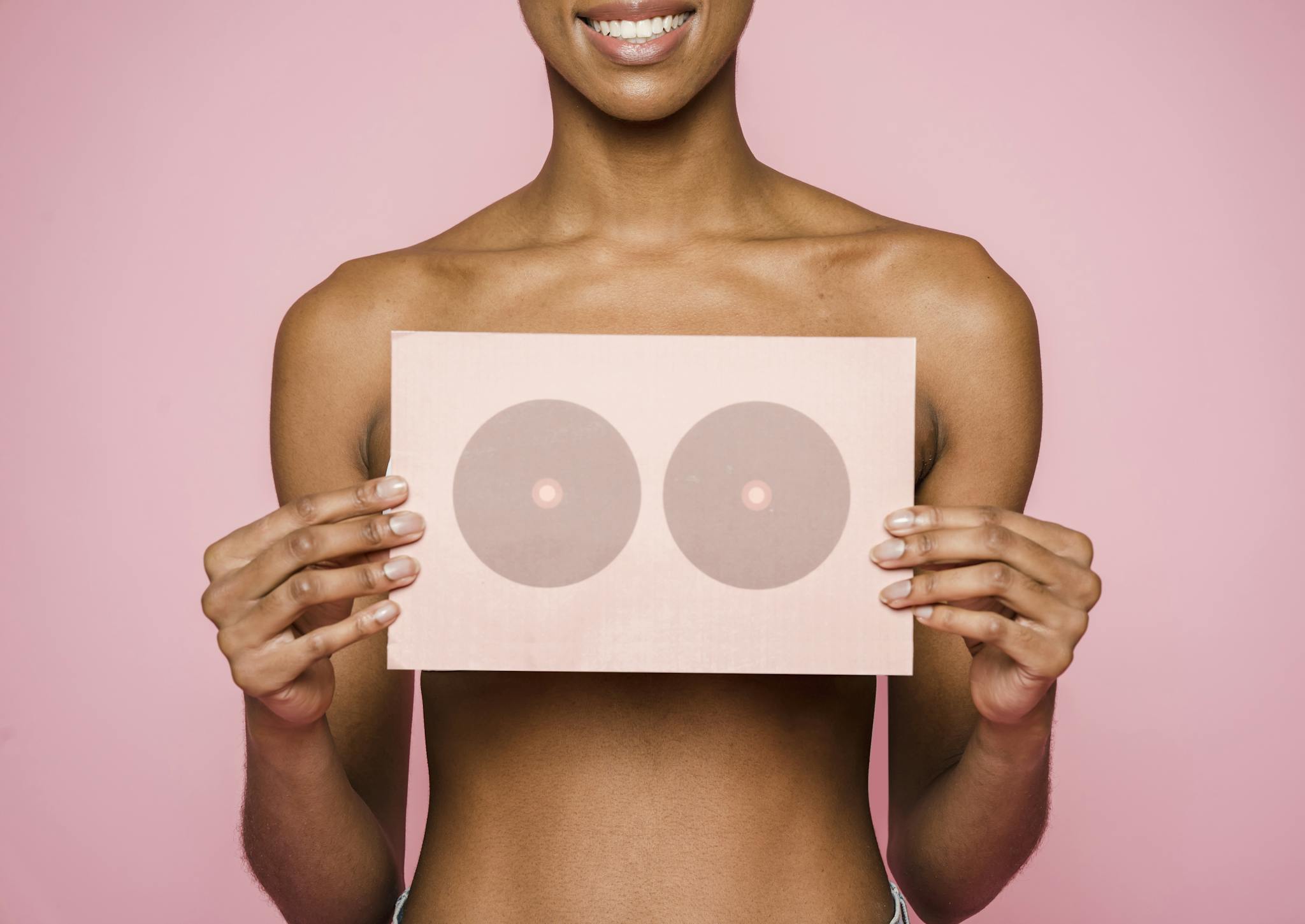 A conceptual image highlighting breast cancer awareness with a woman holding a symbolic card.
